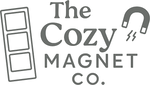 Graphic of The Cozy Magnet Co brand logo featuring a transparent background and stone-grey font color